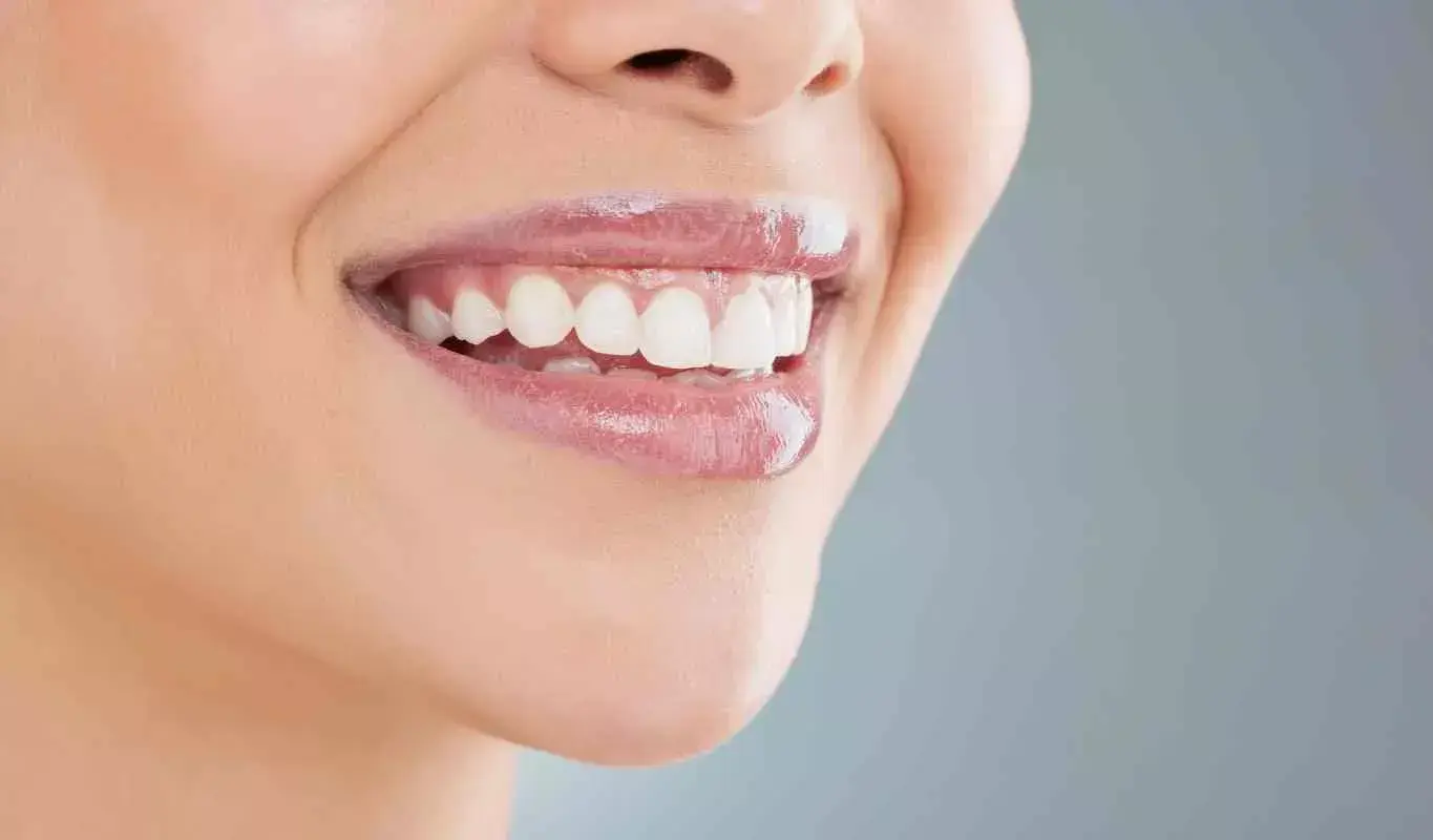 A smiling person showcases a healthy smile, highlighting dental care at Newport Dental Arts in Newport Beach, CA.